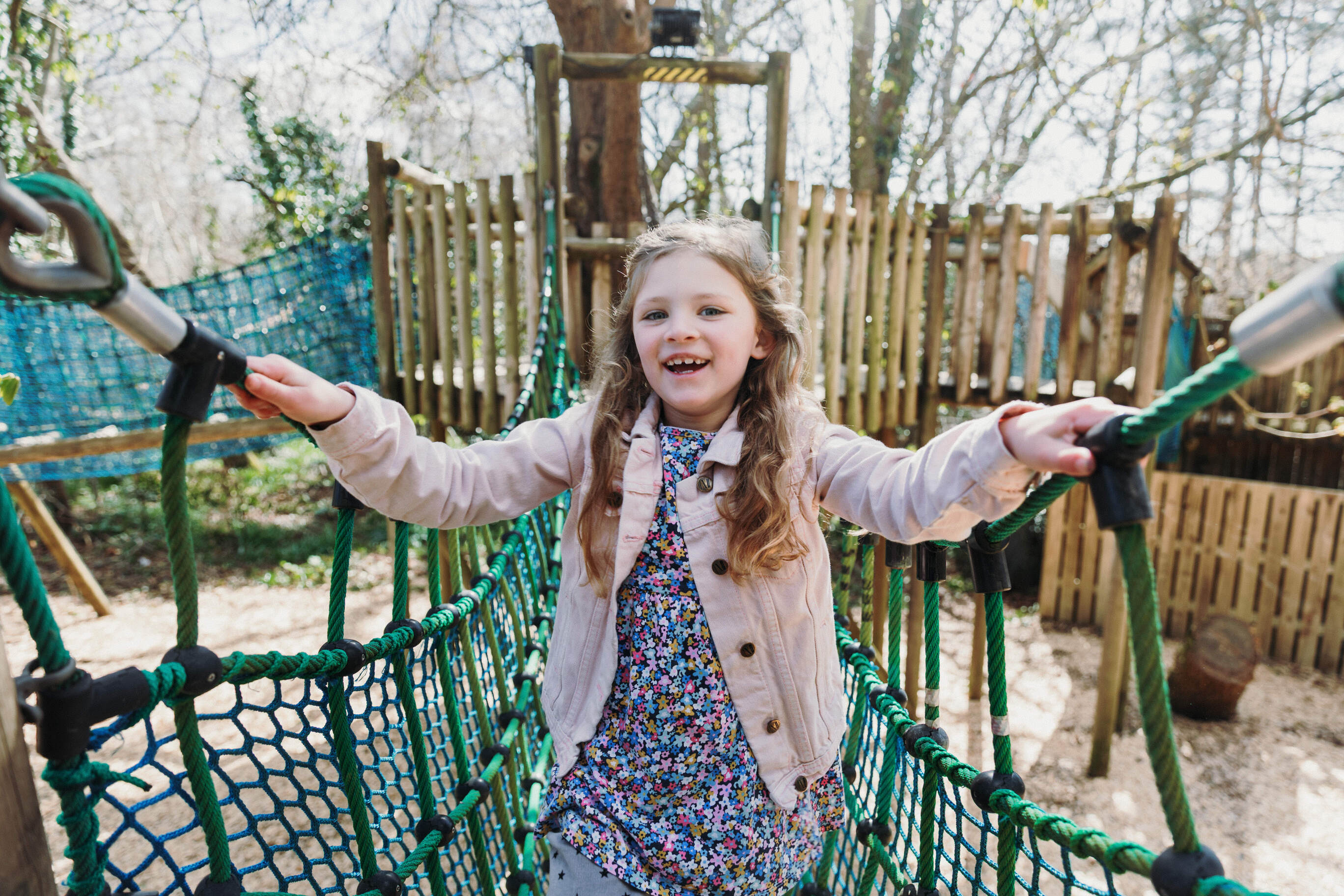 young girl smiling on an outdoor play area